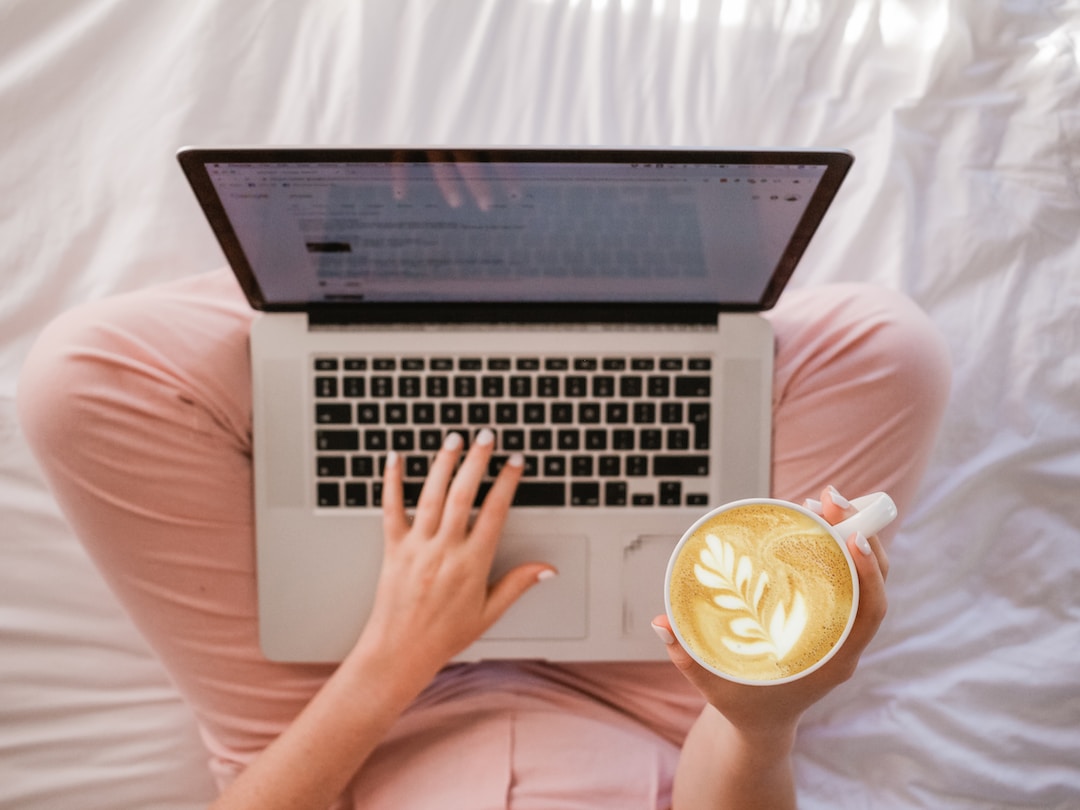 A blogger holding coffee while generating real estate blog topics.
