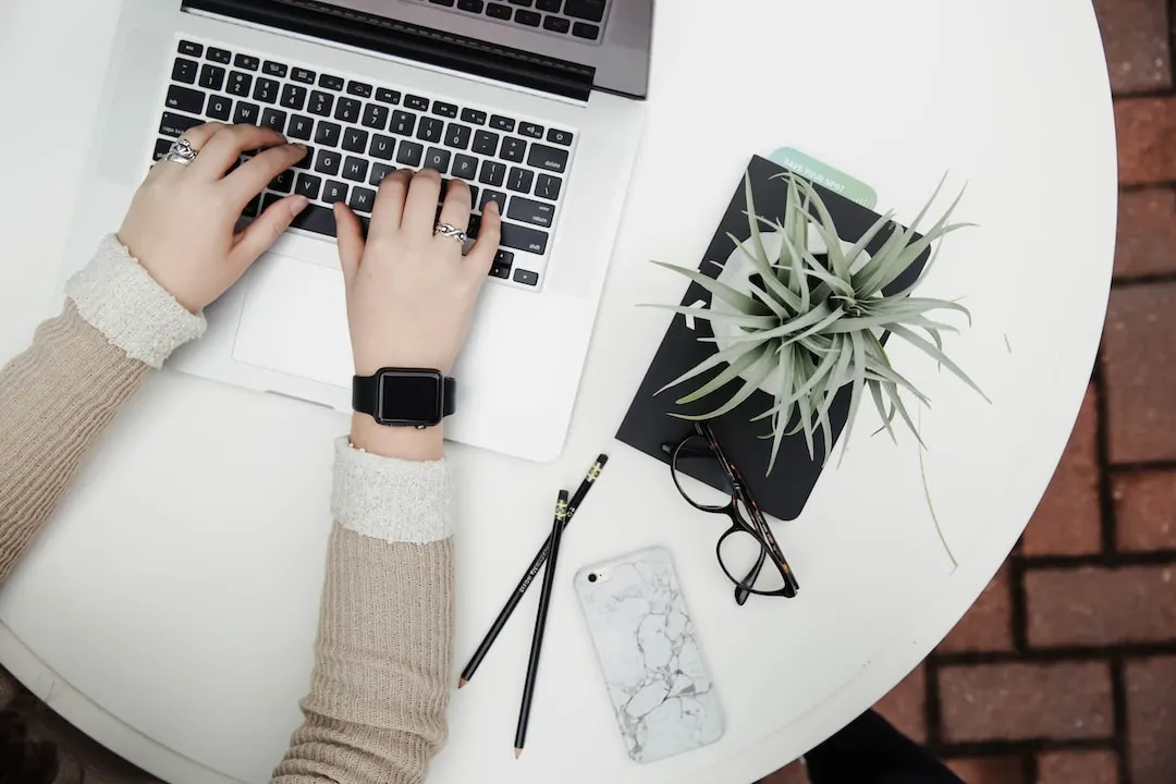 A therapist prepares to generate mental health blog topics on a laptop.